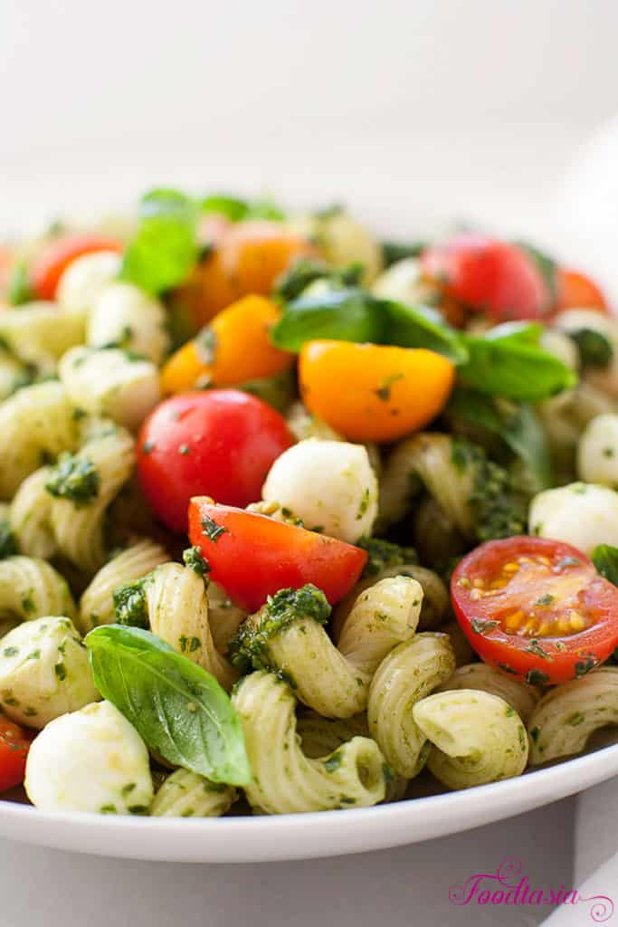 Full of fragrant basil, juicy sweet tomatoes, garlicky pesto, and creamy fresh mozzarella, Pasta Caprese with Pesto, Cherry Tomatoes, and Fresh Mozzarella is bursting with fresh summer flavors. Delicious served warm or cold.
