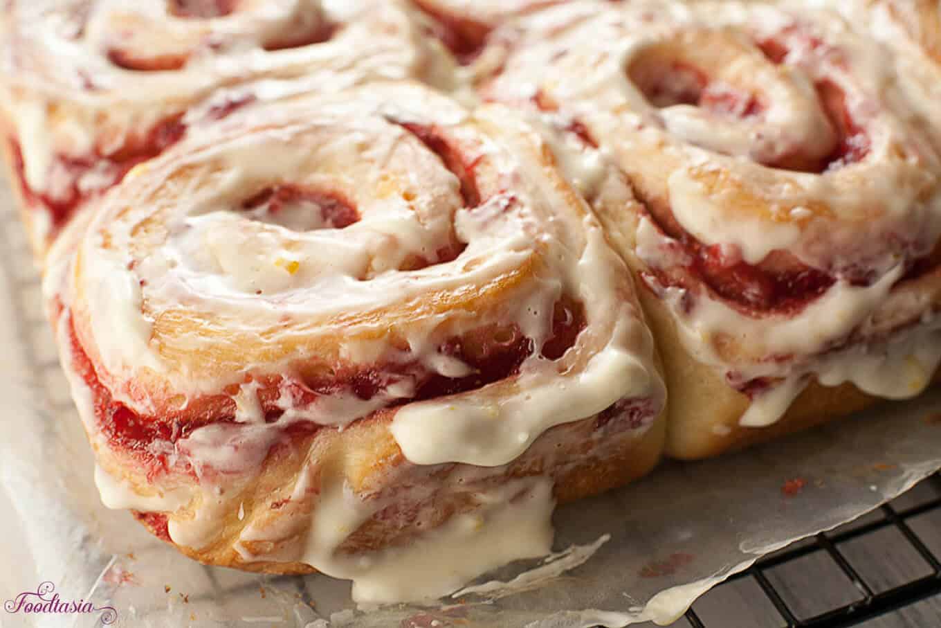 A soft, tender roll enveloping a sweet and tangy fresh strawberry swirl, topped with a cream cheese glaze with a hint of lemony citrus. Fresh Strawberry Sweet Rolls with a Lemony Cream Cheese Glaze make a delightful breakfast.