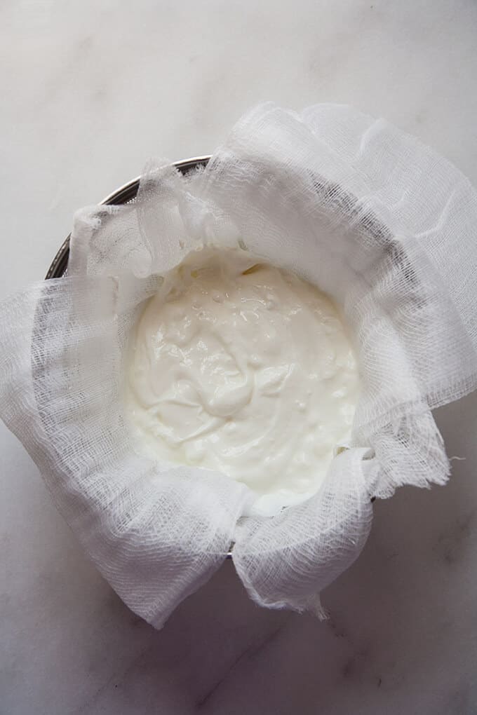 Do you love the thick, creamy, silky smooth texture and luscious, slightly tangy taste of Greek Yogurt but hate paying a premium for it at the supermarket? Making Greek Yogurt at home from regular yogurt is easy and economical.