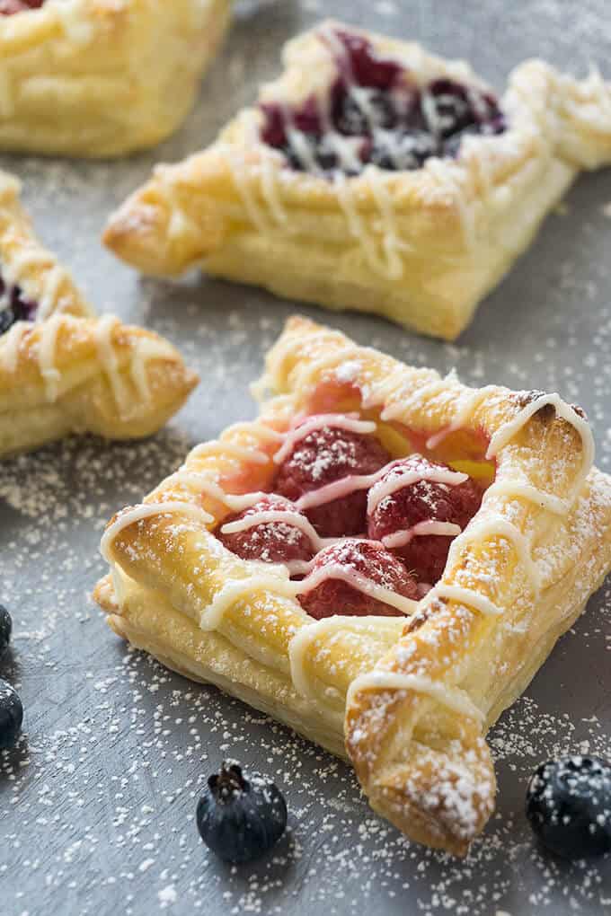 There are so many different textures going on in these pastries: buttery, flaky layers that are so light and airy with crispy, crunchy edges. Tart, juicy berries nestled in a rich, creamy, sweet filling. Each bite is delightful!