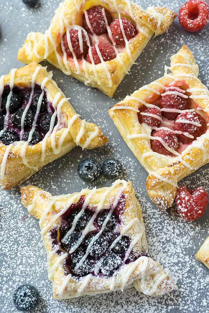 There are so many different textures going on in these pastries: buttery, flaky layers that are so light and airy with crispy, crunchy edges. Tart, juicy berries nestled in a rich, creamy, sweet filling. Each bite is delightful!