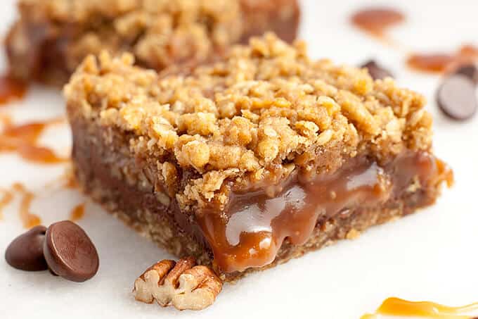 Chewy, gooey Salted Caramel Oatmeal Carmelitas - pockets of gooey, salted caramel oozing out from in between chunks of chocolate and crunchy pecans, all nestled in a brown sugar, oatmeal cookie crust and topped with an oatmeal streusel topping - Caramel Euphoria!