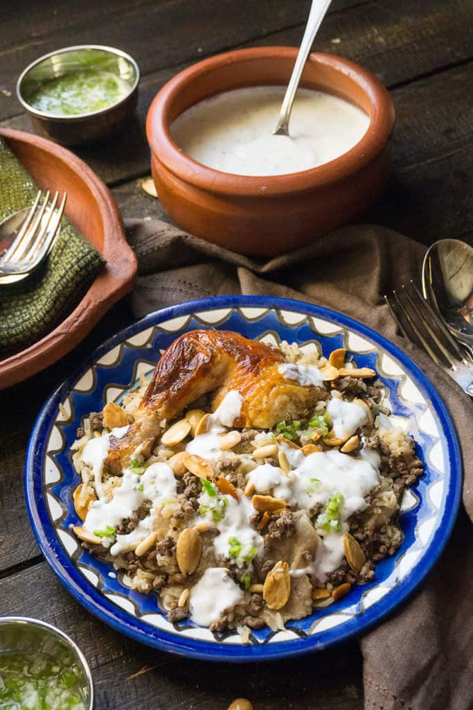 Middle Eastern Chicken and Rice Fattah is a glorious dish with a riot of textures and flavors. A layered dish of saj bread, aromatic rice, fragrant spiced meat, crunchy nuts, juicy chicken, a garlicky chili sauce, and a cool minty yogurt sauce.