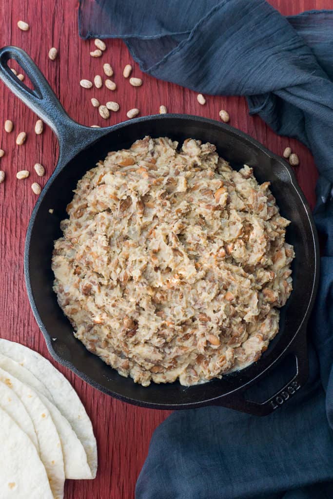 These Easy Homemade Refried Beans are fragrant with onion, garlic, and earthy pinto beans with a hint of smoky bacon.