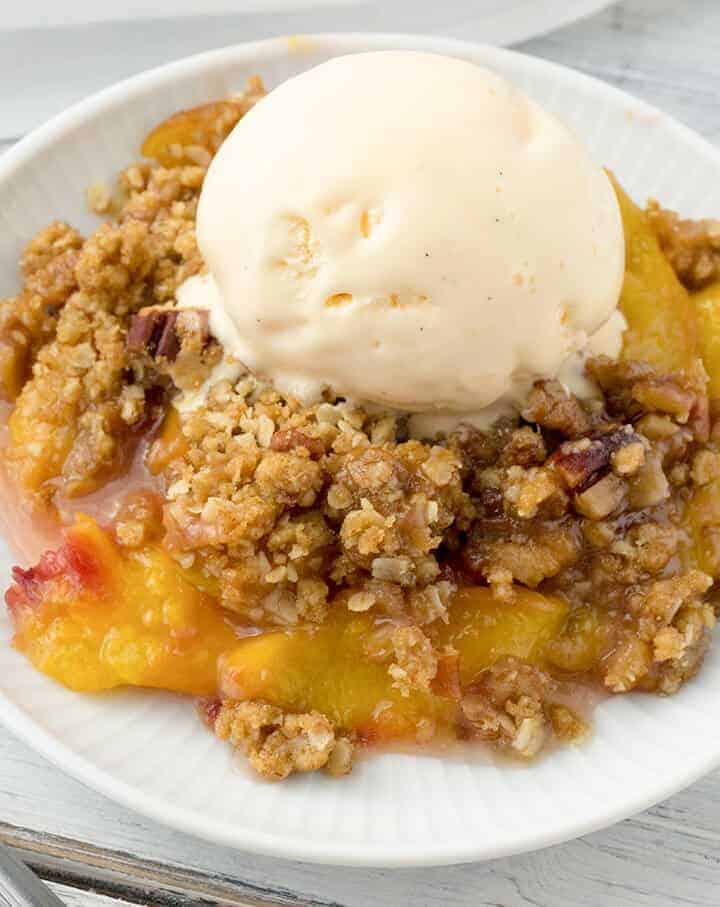 This Peach Crisp is wonderfully delicious with slices of fragrant, juicy, ripe peaches and a crunchy, sweet topping of brown sugar, oatmeal, and pecans