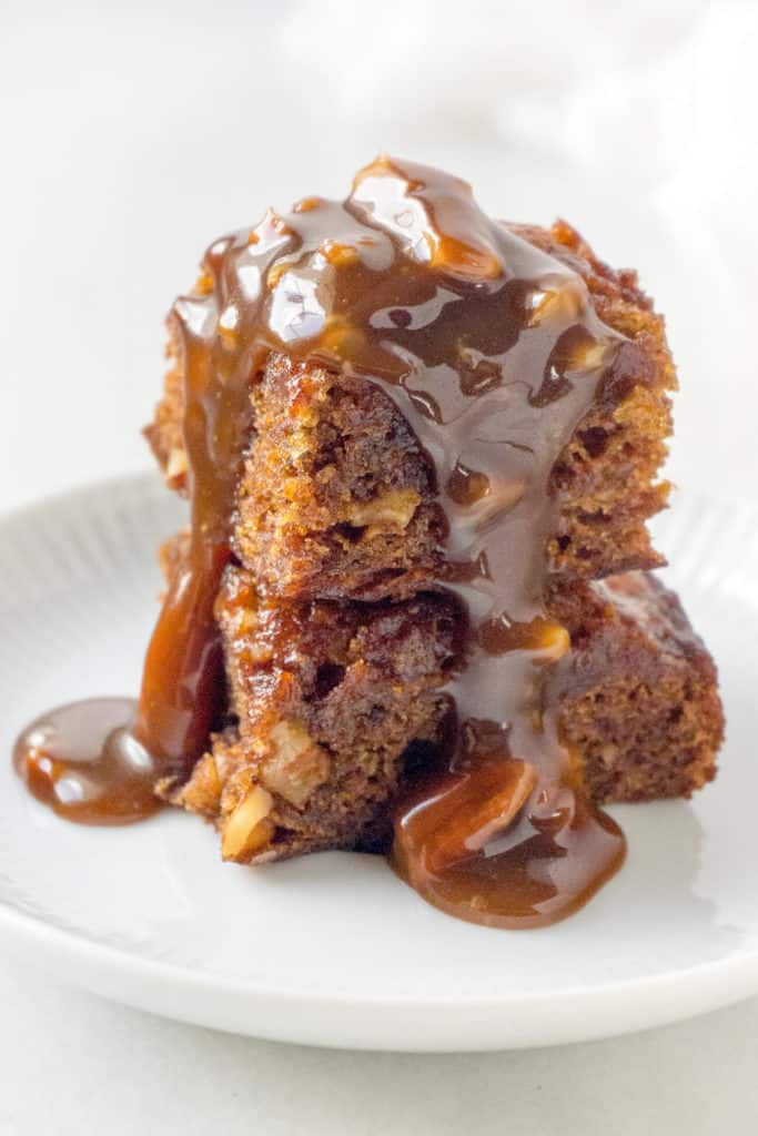 This wonderfully delicious Amish Country Date Nut Pudding is dense, moist, and very rich -  topped with a Pecan Praline Sauce and a dollop of whipped cream – it’s heavenly!
