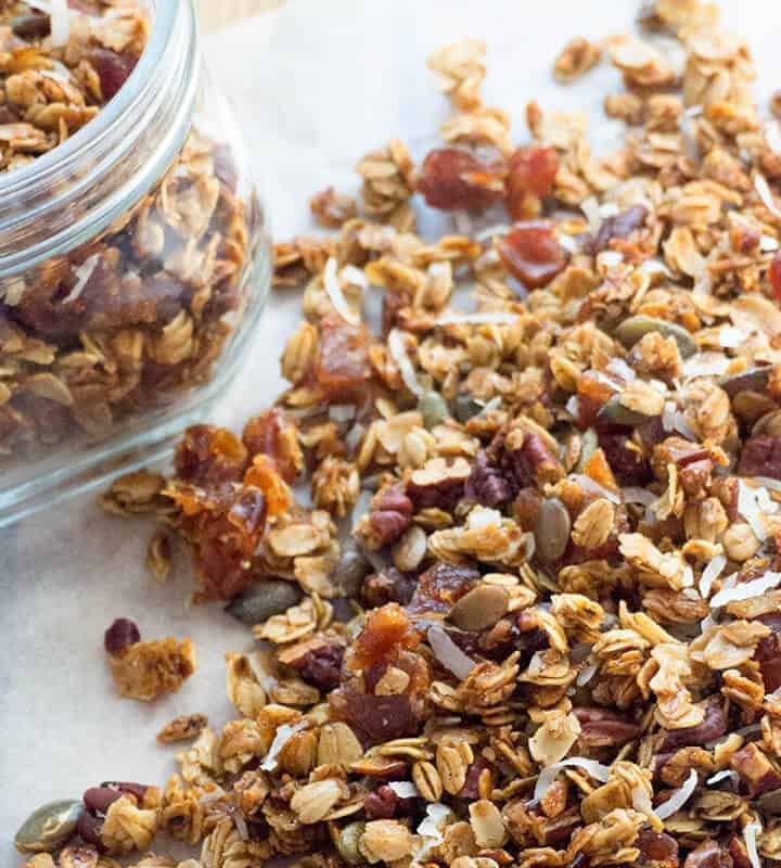 Pumpkin Spice Granola - Crunchy clusters of maple sweetened granola with whole rolled oats, pecans, dates, pepitas, coconut and warm pumpkin spice. Healthy, delicious, and so easy to make!