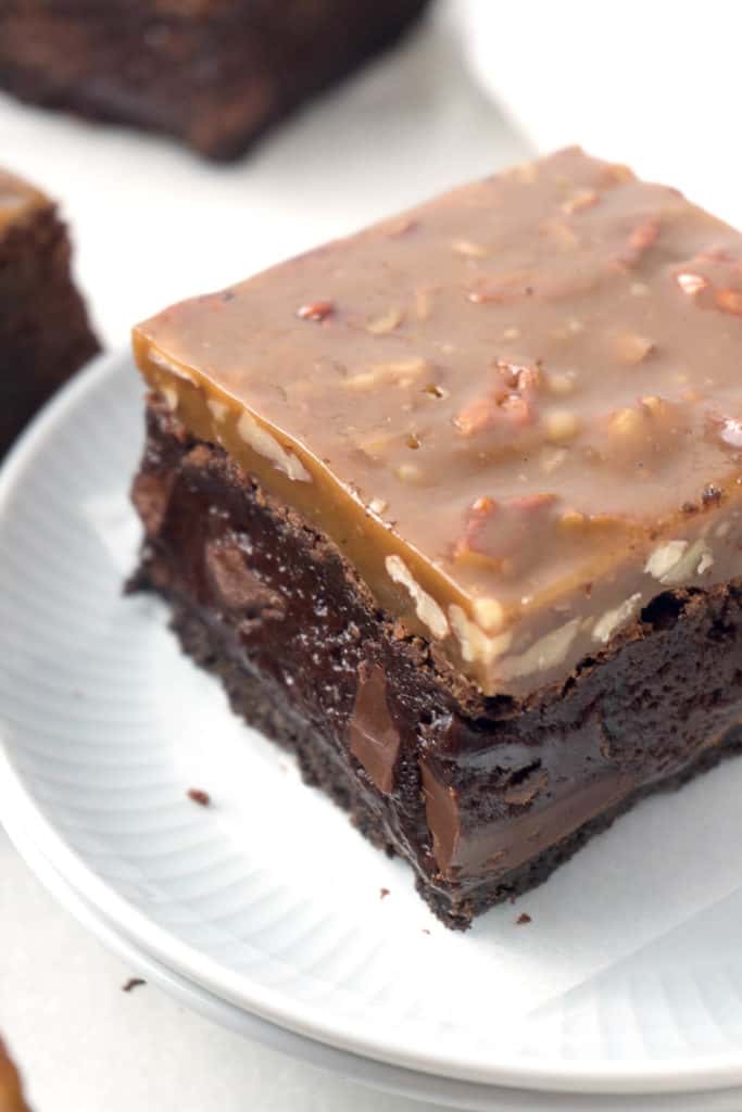 Triple-layer Fudgy Caramel Pecan Turtle Brownies - a dense, fudgy brownie on top of an Oreo cookie crust topped with a chewy caramel and pecan topping. 