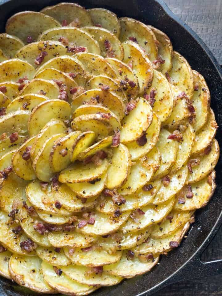 Loaded Bacon and Cheddar Spiral Roasted Potatoes are arranged in a vertical spiral for maximum crispness, roasted with bacon tucked into every little crevice, then topped with cheddar, chives, and sour cream. The BEST potato dish!