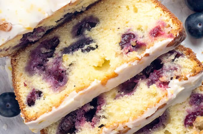 Double Glazed Blueberry Lemon Pound Cake - A moist, tender pound cake, infused with the bright and sunny flavor of lemon, bursting with sweet juicy blueberries, and topped with two (2!) glazes - one vibrant and tangy, one creamy and sweet.