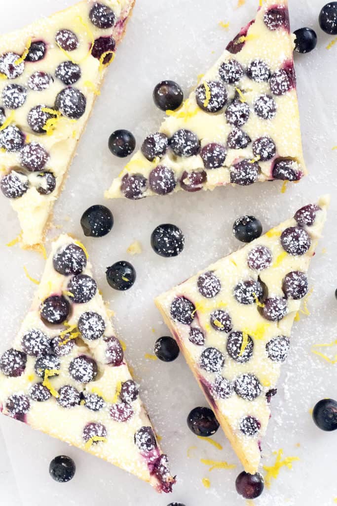 Lemon Blueberry Cheesecake Bars - rich, creamy cheesecake with flecks of lemon zest and studded with juicy blueberries on a shortbread crust. All the deliciousness of cheesecake in a quick and easy bar. 