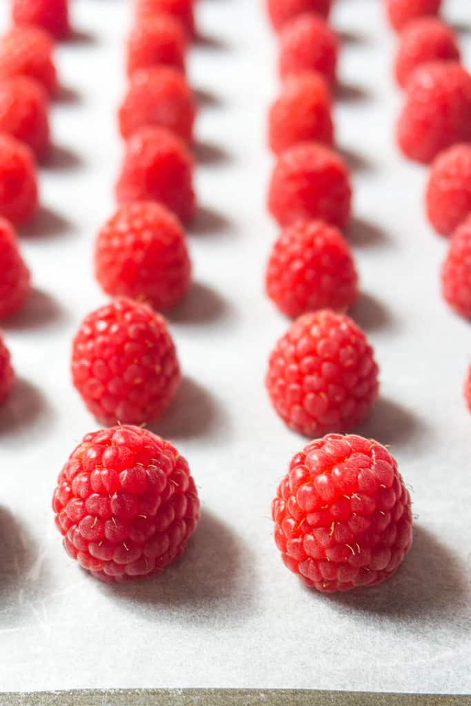 These DIY Oven Dried Raspberries are perfect for baking, granola, trail-mixes, and cereals. Grind them up into a powder to use when you want real raspberry flavor and color but not the liquid - think raspberry frosting! But the best reason to make these DIY Oven Dried Raspberries is White Chocolate Raspberry Cookies!