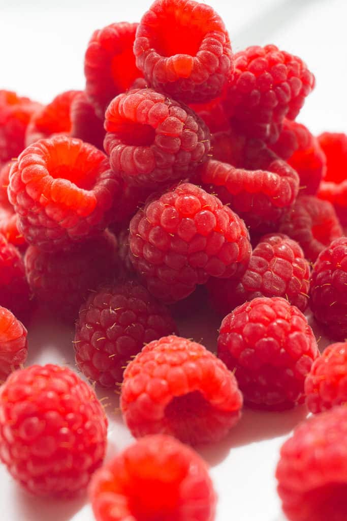 These DIY Oven Dried Raspberries are perfect for baking, granola, trail-mixes, and cereals. Grind them up into a powder to use when you want real raspberry flavor and color but not the liquid - think raspberry frosting! But the best reason to make these DIY Oven Dried Raspberries is White Chocolate Raspberry Cookies!