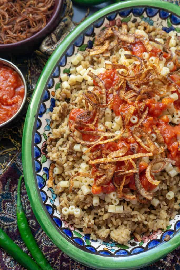 Kushari is Egyptian comfort food at its finest. With cumin scented lentils and rice topped with pasta, a spicy, vinegary tomato sauce, and crispy fried onions, Kushari is a real carb fest - and it's totally addictive! 