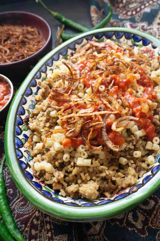 Kushari is Egyptian comfort food at its finest. With cumin scented lentils and rice topped with pasta, a spicy, vinegary tomato sauce, and crispy fried onions, Kushari is a real carb fest - and it's totally addictive!