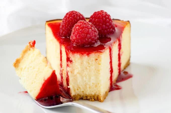 Ultra-smooth, rich and creamy white chocolate cheesecake on a buttery shortbread cookie crust, topped with raspberry sauce and fresh raspberries, this White Chocolate Raspberry Cheesecake is a favorite flavor combination.
