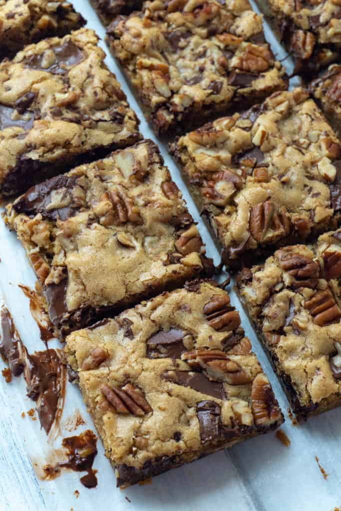 Chewy Chocolate Chunk Blondies are rich and chewy with a hint of butterscotch flavor and packed with chocolate chunks and roasted pecans. Super quick and easy to make, they mix up by hand in just one bowl. A family favorite!