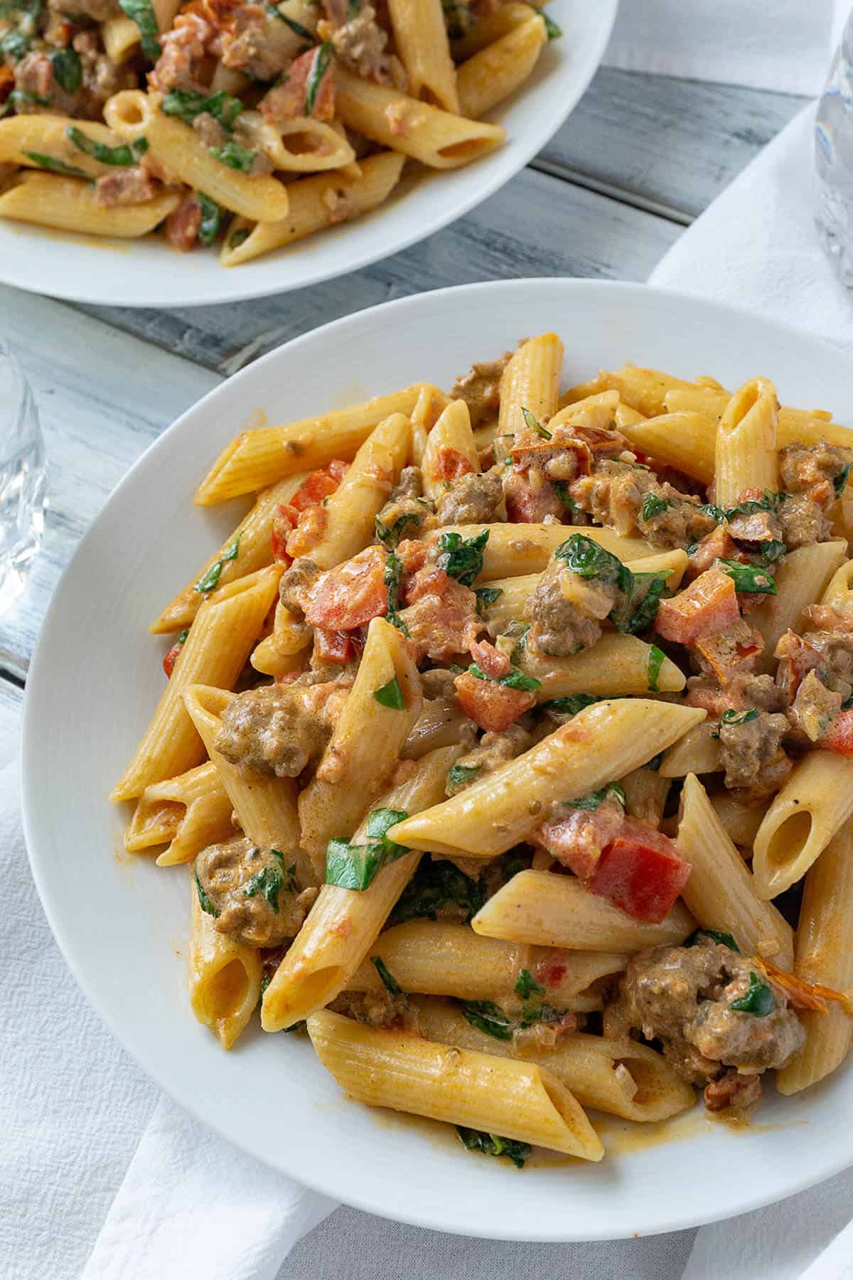 Creamy Italian Sausage and Tomato Pasta | Foodtasia