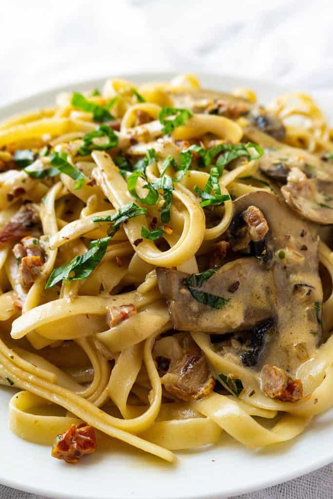 Pasta tossed with sun-dried tomatoes and sautéed mushrooms in a creamy, cheesy sauce fragrant with garlic and basil, this Sun-Dried Tomato and Mushroom Pasta is sure to become a family favorite. Quick and easy to make, it's perfect for a weeknight dinner.