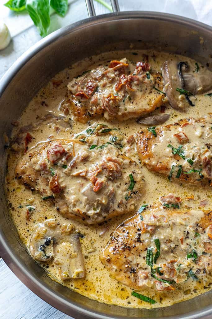 Tender, juicy chicken breasts in a creamy parmesan sauce with sun dried tomatoes and mushrooms - this Chicken with Sun Dried Tomato Cream Sauce is full of flavor and ready in under 30 minutes. Elegant enough for a date night, quick and easy enough for a weeknight dinner. Sure to be a family favorite!