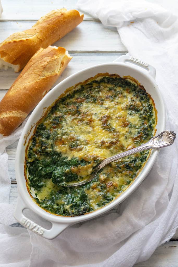 This Creamy, Cheesy Spinach Gratin is full-on flavor! Fresh spinach in a creamy, cheesy sauce baked until bubbly and golden. You won’t believe it’s light and healthy with no cream. The whole family agrees – it’s the best spinach we’ve ever eaten.