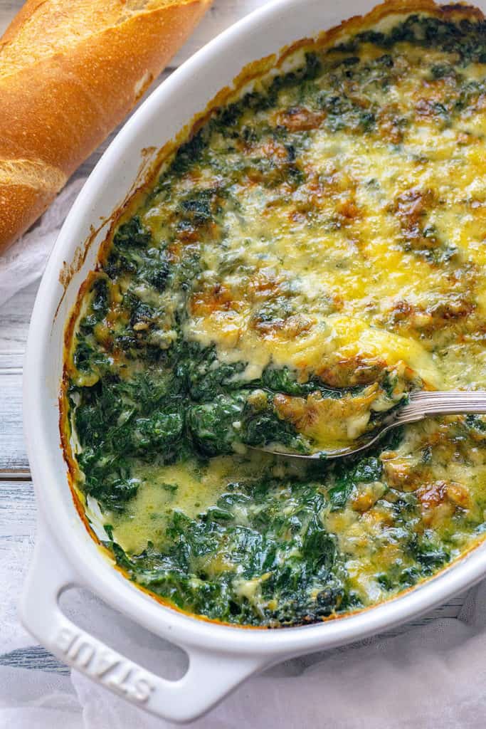 This Creamy, Cheesy Spinach Gratin is full-on flavor! Fresh spinach in a creamy, cheesy sauce baked until bubbly and golden. You won’t believe it’s light and healthy with no cream. The whole family agrees – it’s the best spinach we’ve ever eaten.