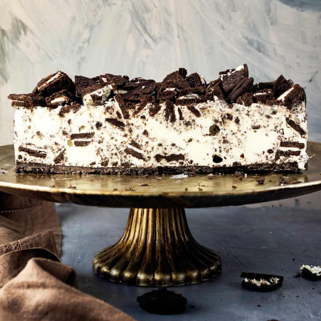 So delicious and super easy! Oreos and vanilla ice cream are a match made in heaven! This Oreo Ice Cream cake has an amazingly delicious Oreo cookie and vanilla ice cream filling, sitting on crunchy Oreo cookie crust, and topped with even more Oreos. Three ingredients, no bake, and you can put it together in just a few minutes. One of my most requested desserts and unbelievably easy to make.
