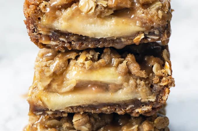 These Salted Caramel Apple Crumb Bars have slices of juicy apples drizzled with caramel, sandwiched in between the BEST brown sugar oat crust and streusel topping. One bowl and so easy to make. Same dough for crust and topping - it's moist, it's crunchy, and it has the most amazing buttery, caramel flavor