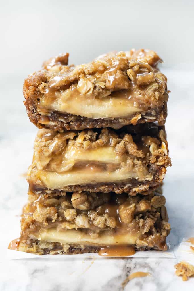These Salted Caramel Apple Crumb Bars have slices of juicy apples drizzled with caramel, sandwiched in between the BEST brown sugar oat crust and streusel topping. One bowl and so easy to make. Same dough for crust and topping - it's moist, it's crunchy, and it has the most amazing buttery, caramel flavor