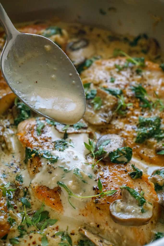 This quick and easy Creamy Garlic Parmesan Mushroom Chicken is so full of flavor, the whole family will love it. Tender, juicy chicken in a creamy sauce fragrant with garlic and parmesan with sautéed mushrooms and baby spinach - so delicious and on the table in 15 minutes. This is one chicken recipe you'll want to make time and time again!