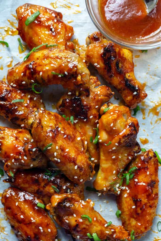 Delightfully sticky and perfectly crisp, these Baked Honey Sriracha Chicken wings are spicy, sweet, and oh so delicious! Honey and sriracha are the ultimate combination of sweet and spicy. Lime adds a bit of tang, garlic and soy sauce that umami yum. And then there’s butter….These wings have ALL THE FLAVOR. Plus, my secret to giving baked wings maximum crispness.