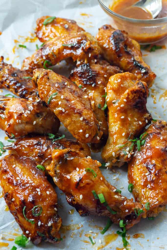 Delightfully sticky and perfectly crisp, these Baked Honey Sriracha Chicken wings are spicy, sweet, and oh so delicious! Honey and sriracha are the ultimate combination of sweet and spicy. Lime adds a bit of tang, garlic and soy sauce that umami yum. And then there’s butter….These wings have ALL THE FLAVOR. Plus, my secret to giving baked wings maximum crispness. 