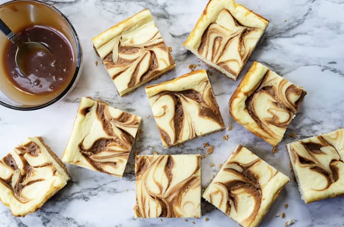 Swirled Caramel Cheesecake Bars - rich, creamy, and velvety smooth cheesecake on top of a sweet, crunchy, shortbread crust, with swirls of rich caramel. All the deliciousness of cheesecake in a quick and easy bar! #cheesecake #cheesecakerecipe #cheesecakebars #bars #caramel #dessert #quick #easy #cheesecakerecipes