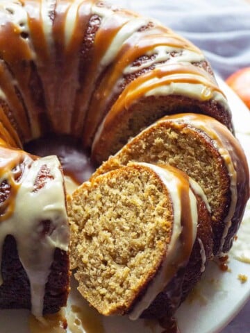 This Triple Glazed Caramel Apple Cider Cake is bursting with apple and the flavors of autumn! Shredded apples and an intense apple cider syrup flavor the moist, tender cake. Three glazes send it right over the top - an apple cider syrup glaze, an apple cider icing, and a caramel drizzle. #applecake #applecidercake #apple #applecider #falldesserts #desserts #dessertrecipes #recipe #easy #caramel #cake #bundt #easydessert #dessertfoodrecipes #easyrecipes #cakerecipes #bundtbakers #bundtcake