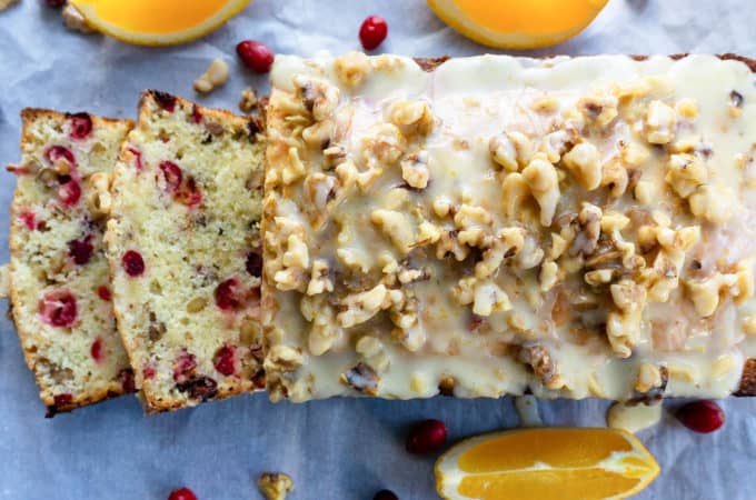 This Cranberry Orange Walnut Bread is bursting with fresh cranberries, orange juice and zest, and roasted walnuts. Topped with a bright and citrusy orange and walnut glaze, it’s the perfect treat for the holiday season! #cranberry #cranberrybread #cranberryrecipe #cranberryorange #recipes #holidayrecipes