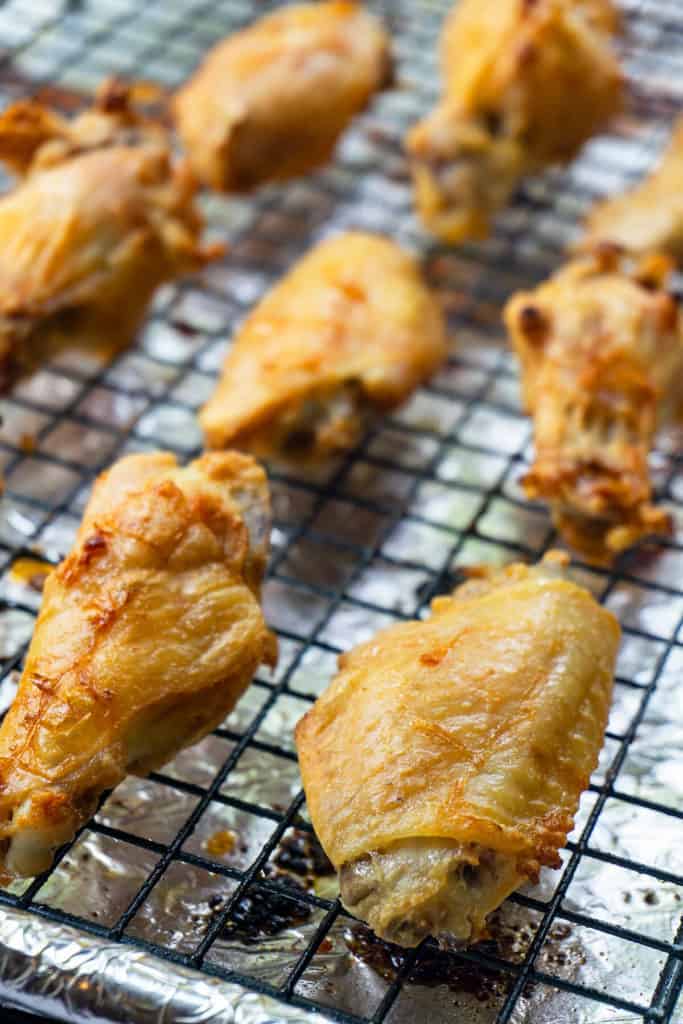 These easy Baked Chicken Wings are amazingly crispy and crunchy. With a surprise ingredient that you probably have on hand and a simple technique, you can have Super Crispy Baked Chicken Wings with minimal effort. #wings #chickenwings #bakedwings #bakedchickenwings #recipe #easyrecipe #appetizers #appetizerrecipes #appetizerseasy #appetizersforparty #gamedayrecipes #gamedayfood