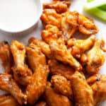 These easy Baked Chicken Wings are amazingly crispy and crunchy. With a surprise ingredient that you probably have on hand and a simple technique, you can have Super Crispy Baked Chicken Wings with minimal effort. #wings #chickenwings #bakedwings #bakedchickenwings #recipe #easyrecipe #appetizers #appetizerrecipes #appetizerseasy #appetizersforparty #gamedayrecipes #gamedayfood