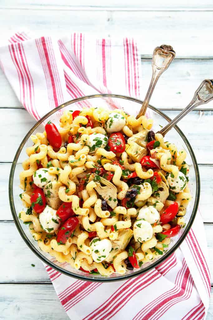 Everyone loves this Easy Italian Antipasto Pasta Salad! It’s filled with the delicious flavors of your favorite Italian antipasto tossed with a homemade dressing. My go-to recipe for a quick meal, picnic, or potluck. #pasta #salad #Italian #antipasto #artichoke #marinated #redpepper #picnic #potluck #easy #quick #recipe #dinner
