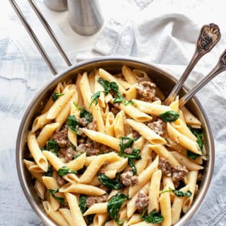 Creamy Italian Sausage Pasta - pasta with sausage and spinach in the creamiest, garlicky parmesan sauce. Pure comfort food on the table in under 30 minutes! #pasta #recipe #easy #quick #under30minutes #easydinner #easyrecipes #sausage #creamy #weeknight #datenight