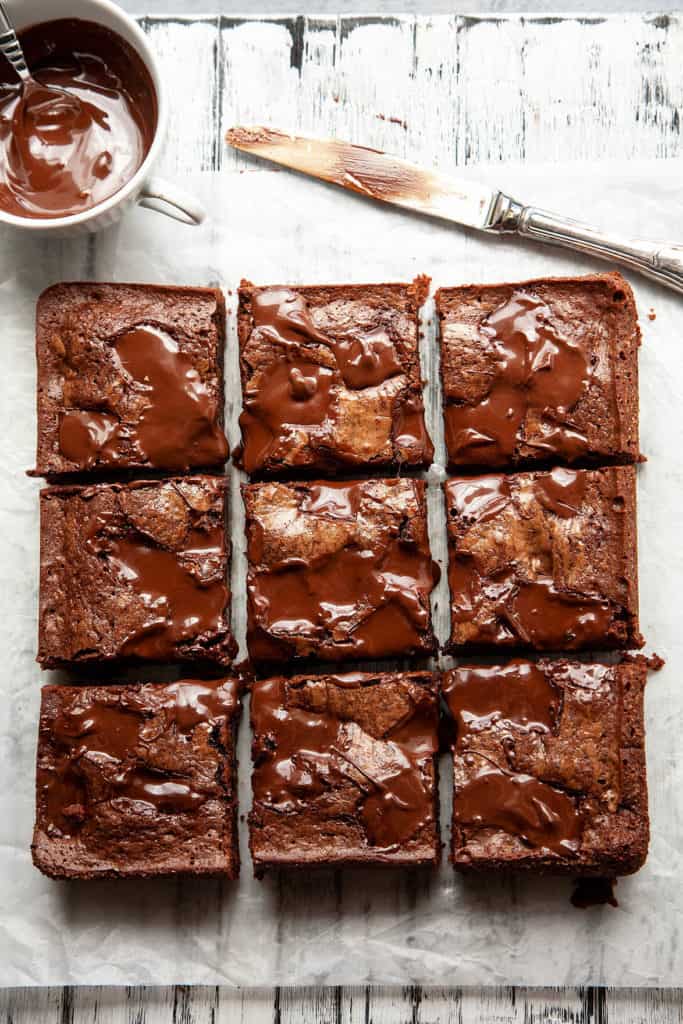 These Ultimate Fudgy, Chewy Brownies are dense, moist, and intensely chocolatey with a crackly top and puddles of molten chocolate. Somewhere between a rich truffle torte and a piece of fudge, their chewy texture is absolute perfection. #brownies #dessert #fudgy #chewy #chocolate #best #easy