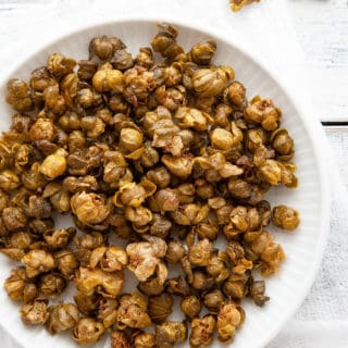 Crispy, nutty, and briny, Fried Capers are magical little flavor bombs that add an incredible dimension of flavor and texture to salads, pasta, meat, and vegetable dishes. #garnish #italian #recipe #easy #quick #flavor #fried #whatare #howtouse