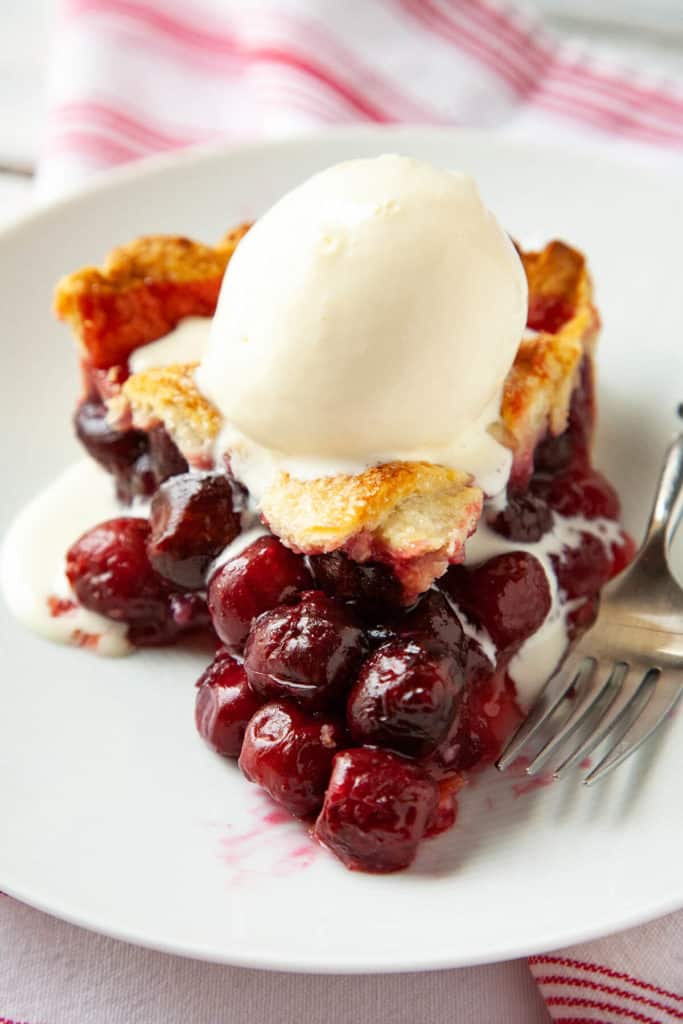 Homemade Cherry Pie is a summertime classic with its buttery, flaky crust and a beautiful, juicy cherry filling #cherry #pie #easy #lattice #tapioca #cornstarch #best #tart #sweet #homemade #fresh #recipe #fromscratch #bing