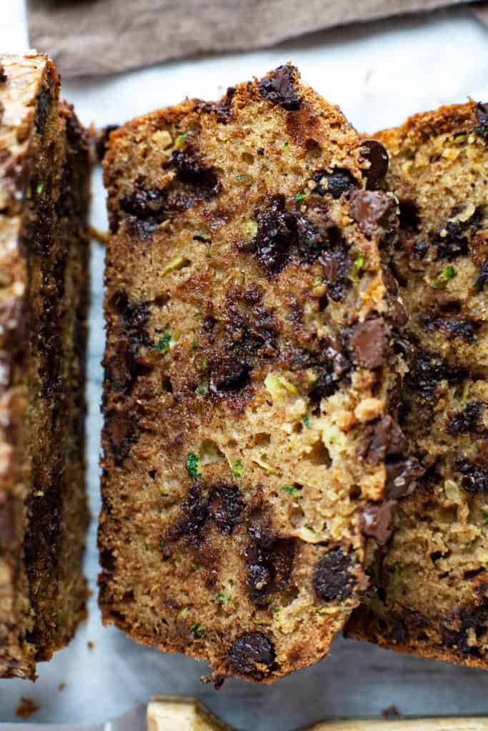 Chocolate Chip Zucchini Bread – elevating a summertime favorite to a whole new level! Super moist and tender, dotted with chocolate chips, and a crispy, crackly sugar-coated top. #zucchini #bread #recipe #chocolatechip #easy #quick #oneloaf #best #simple #moist #withbutter