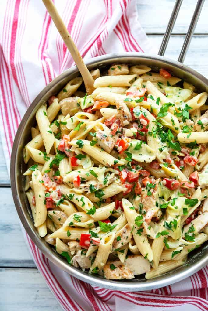 This Creamy Lemon Artichoke Pasta with Chicken, red peppers, and parsley has a bright, delicate lemon flavor in a creamy, garlicky parmesan sauce. An easy and flavorful one dish meal. Restaurant quality in under 30 minutes. #pasta #artichoke #quick #easy #chicken #dinner #creamy #redpepper #lemon #under30minutes #datenight