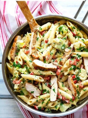 This Creamy Lemon Artichoke Pasta with Chicken, red peppers, and parsley has a bright, delicate lemon flavor in a creamy, garlicky parmesan sauce. An easy and flavorful one dish meal. Restaurant quality in under 30 minutes. #pasta #artichoke #quick #easy #chicken #dinner #creamy #redpepper #lemon #under30minutes #datenight