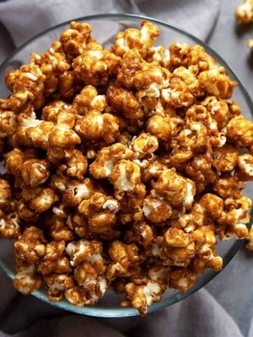 The ultimate easy, Homemade Caramel Corn recipe. Easy to make, stays crispy and crunchy for weeks, and you won’t believe how addictive it is! Perfect for parties, snacking, movie night, and gifting. #caramelcorn #caramelpopcorn #caramel #popcorn #snacks #party #food #recipe #homemade #easy #gift #movienight #video #crunchy