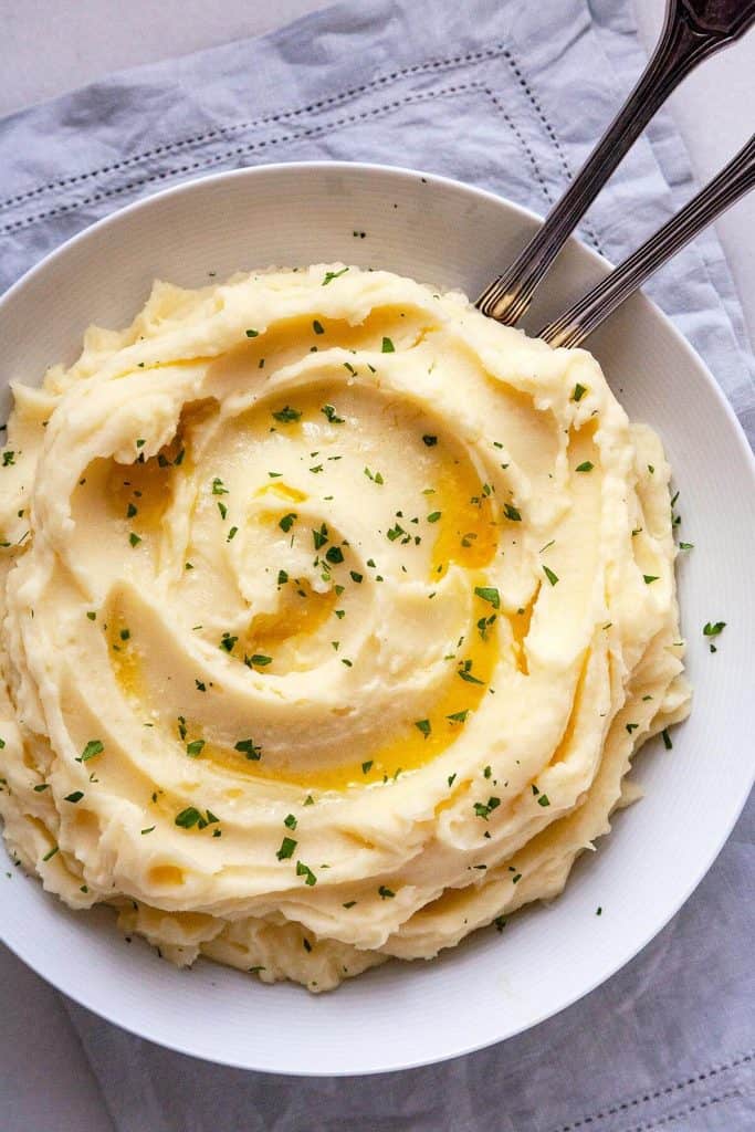 The BEST homemade Mashed Potatoes - deliciously rich and creamy, easy to make, and perfect every time. #easy #recipe #garlic #best #creamy #make ahead #Thanksgiving #homemade #russet #yukon gold #classic