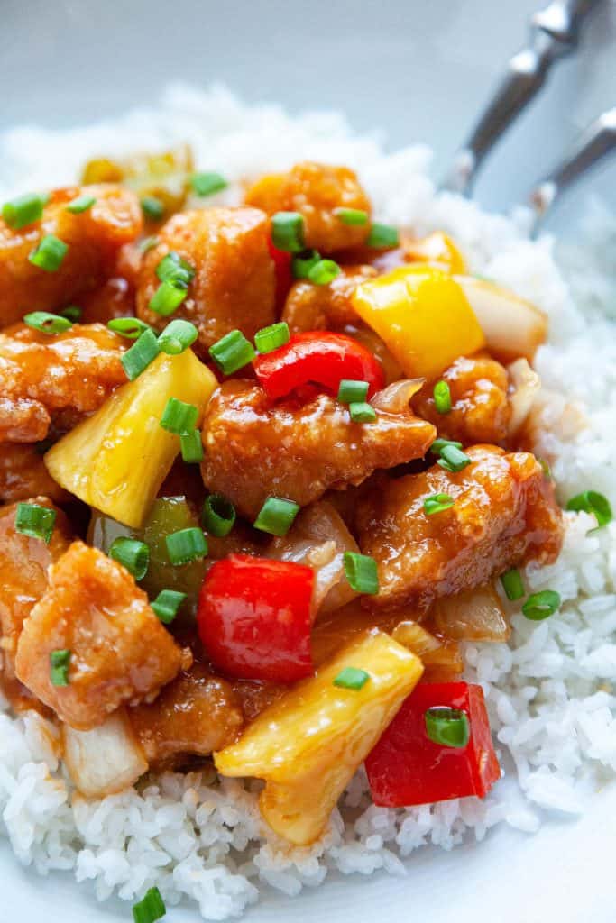 Sweet and Sour Chicken is a Chinese takeout favorite that’s easy to make at home. With crispy chunks of chicken, bell peppers, and pineapple in the most amazing sweet and sour sauce! #sweet and sour #chicken #dinner #chinese #takeout #easy #quick #fried #not fried