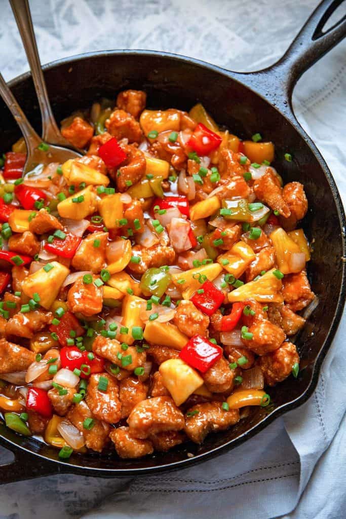 Sweet and Sour Chicken is a Chinese takeout favorite that’s easy to make at home. With crispy chunks of chicken, bell peppers, and pineapple in the most amazing sweet and sour sauce! #sweet and sour #chicken #dinner #chinese #takeout #easy #quick #fried #not fried