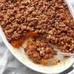 Sweet potato casserole - velvety smooth, sweet potatoes topped with the most amazing sweet, crunchy, pecan and brown sugar streusel. A must have on the Thanksgiving or holiday table. #sweet potatoes #casserole #dinner #Thanksgiving #holiday #from scratch #streusel #side dish #dessert